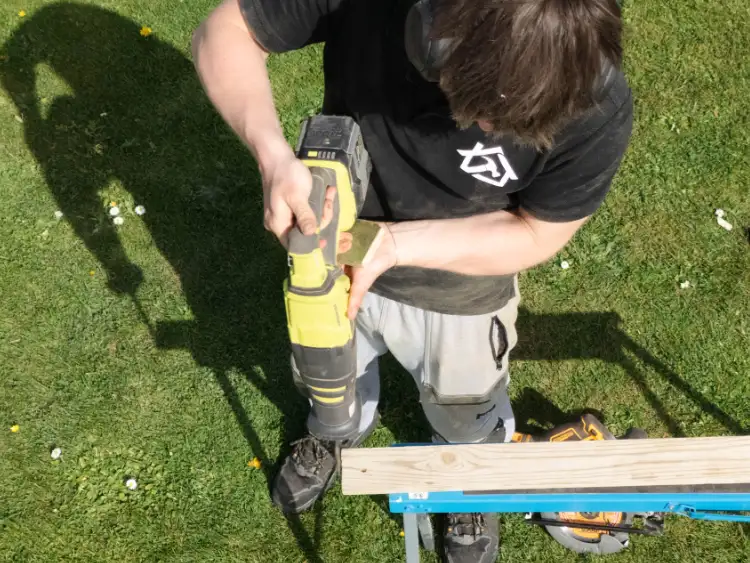 Tradesman using a cordless drill on site